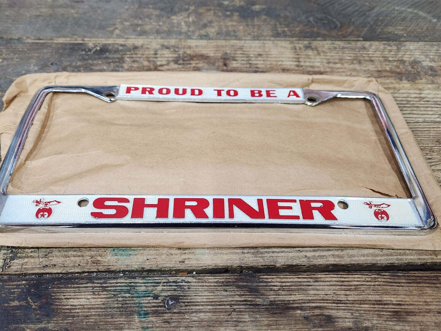 NEW NOS Vintage PROUD TO BE A SHRINER Metal Chrome Embossed License Plate Frame