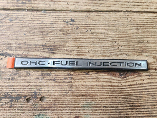 NOS NEW PONTIAC OHC FUEL INJECTION NAME PLATE ORNAMENT EMBLEM ORIGINAL FACTORY