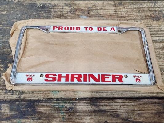 NEW NOS Vintage PROUD TO BE A SHRINER Metal Chrome Embossed License Plate Frame