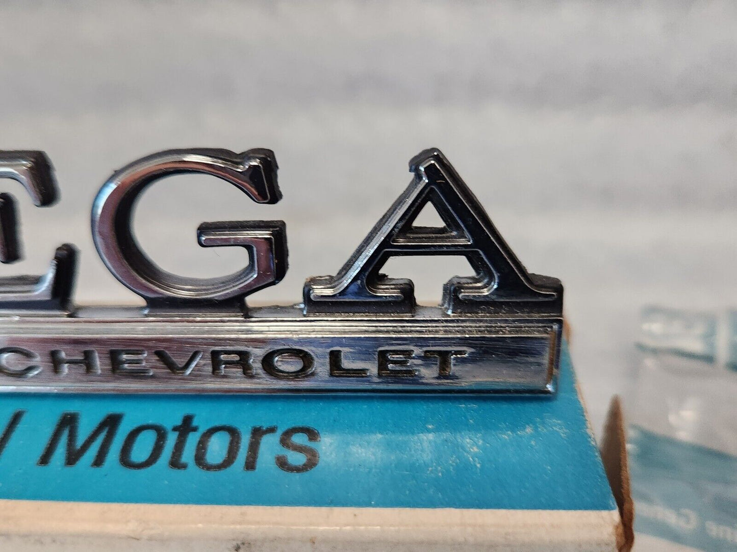 NOS OEM GM 1973-77 Vega Header rear Body Panel Nameplate Emblem 1700895 9633779